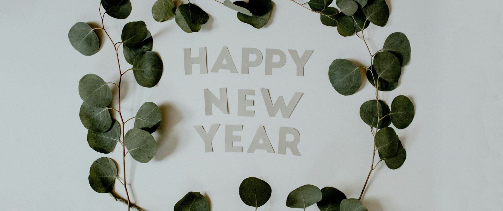 happy new year greeting card with eucalyptus leaves at The  Sutton